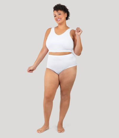 Plus size person, facing front, wearing JunoActive's QuikWik Full Fit plus size underwear in color white on a gray background.