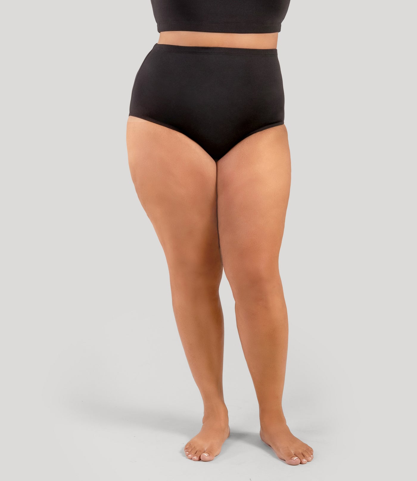 Plus size person wearing JunoActive's QuikWik Plus Size Full Fit plus size underwear on a gray background.