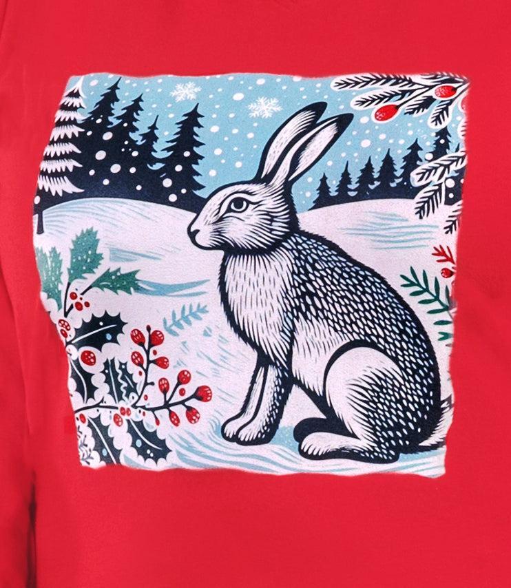 Close up of the Designer Graphic Stretch Naturals plus size Long Sleeve V-Neck Top in Lucky Red. The graphic  is of a rabbit in a winter scene with red berries and green pine leaves.