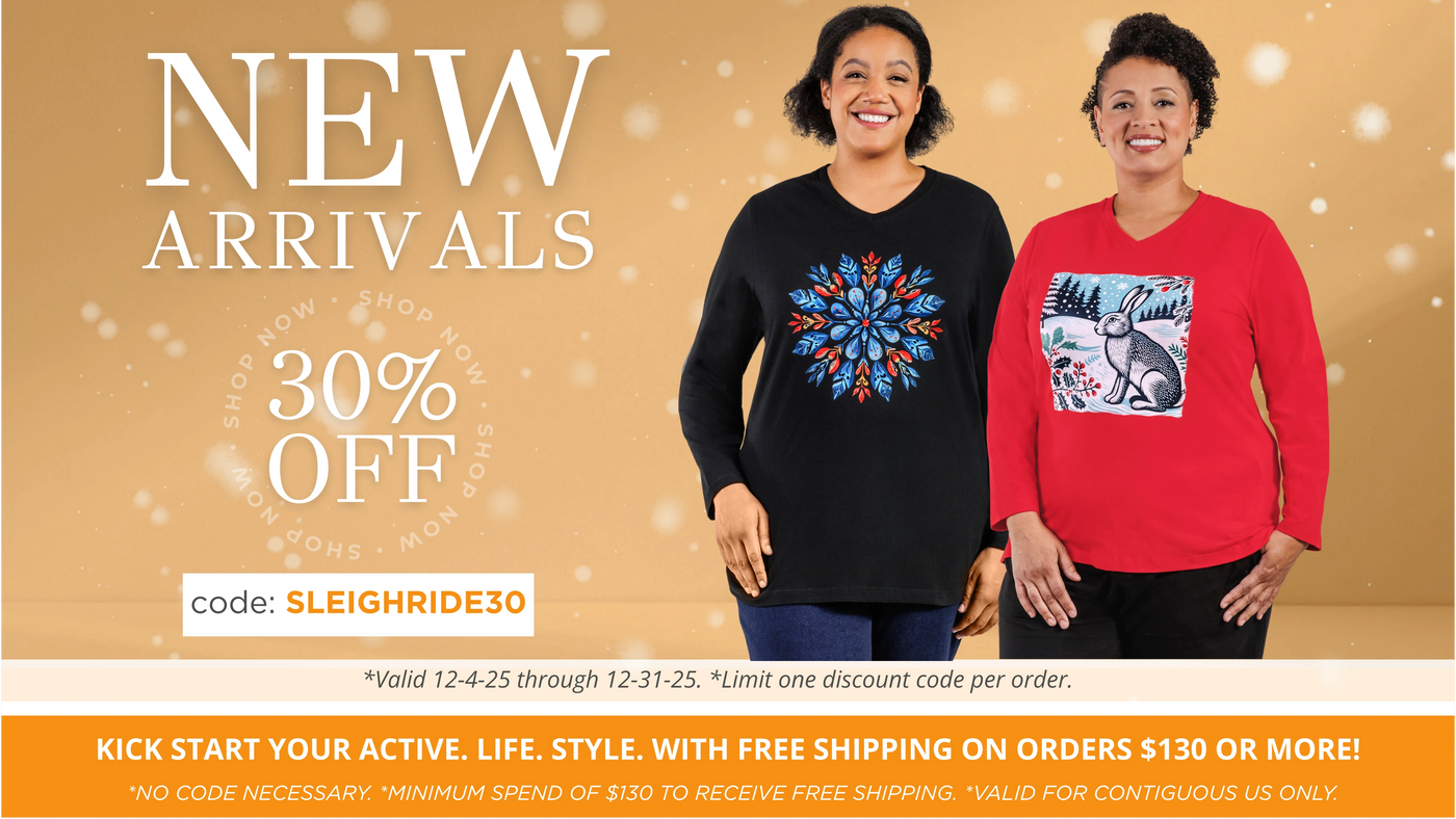Two plus size women wearing JunoActive plus size graphic winter themed long sleeve v-neck tops with 30% off new arrivals promo the month of December with code: SLEIGHRIDE30 on a beige background.