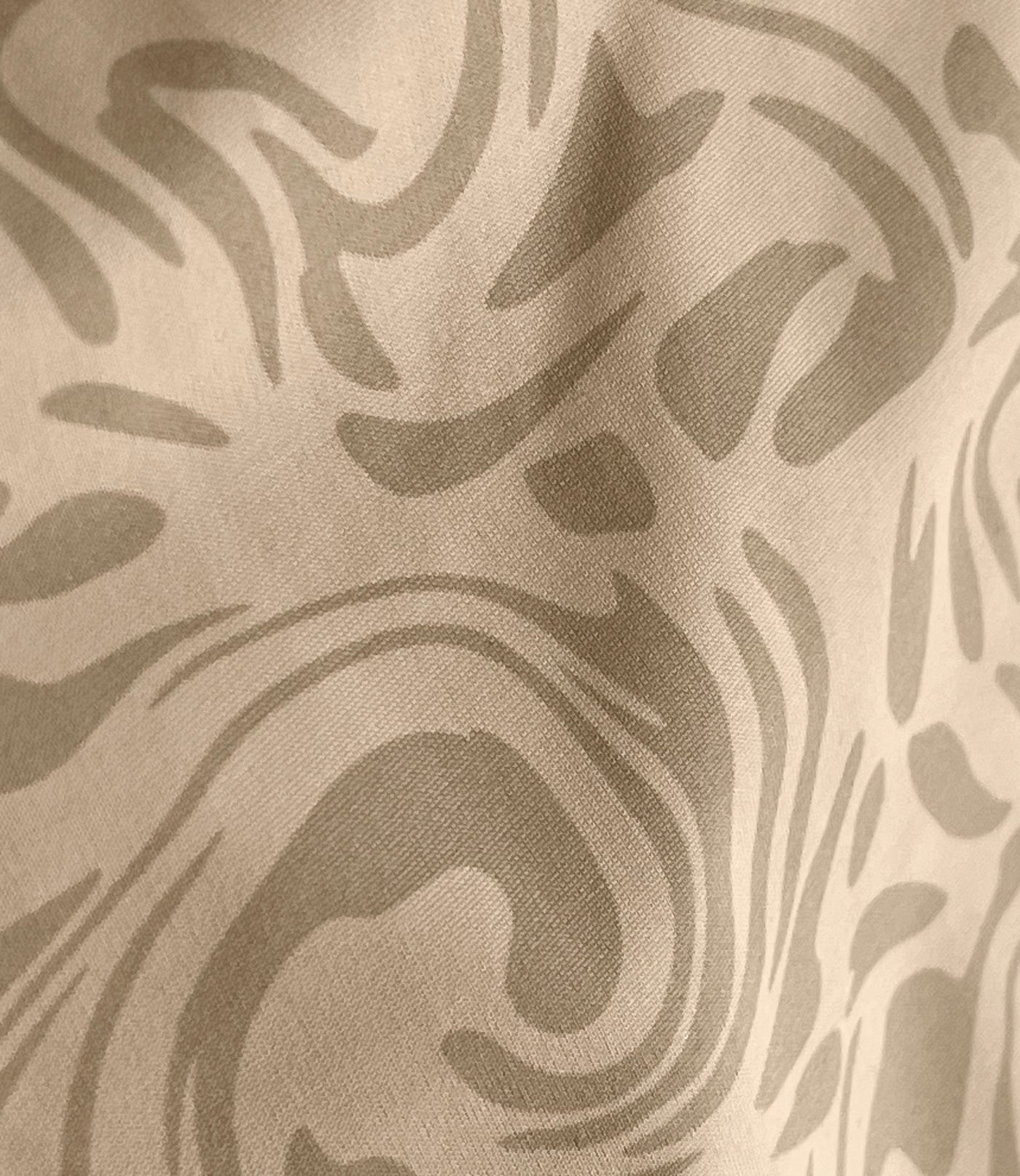 Close-up of ecru swirl pattern.