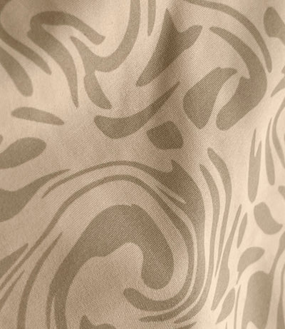 Close-up of ecru swirl pattern.
