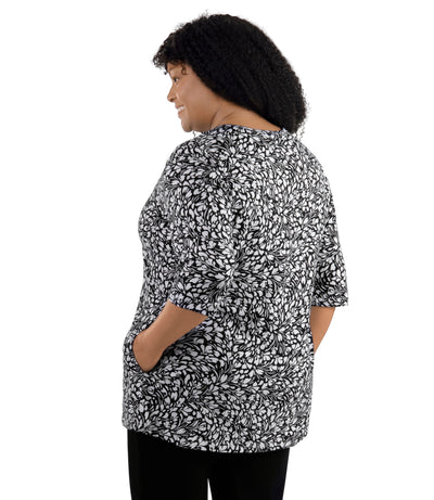 JunoActive Lifestyle Cotton three quarter sleeve pocketed tunic in print Botanic. Model facing back.