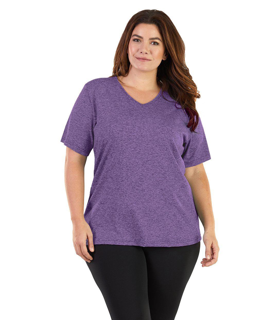 Plus size woman, facing front, wearing JunoActive plus size SoftWik V-Neck Tee in the color Heather Amethyst. She is wearing JunoActive Plus Size Leggings in the color Black. 