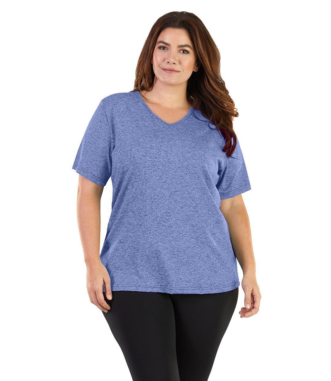 Plus size woman, facing front, wearing JunoActive plus size SoftWik V-Neck Tee in the color Heather Blue. She is wearing JunoActive Plus Size Leggings in the color black. 