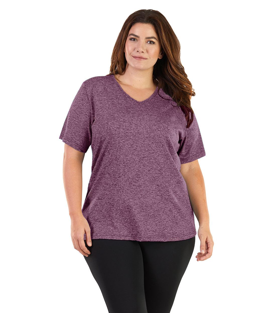 Plus size woman, facing front, wearing JunoActive plus size SoftWik V-Neck Tee in the color Heather Merlot. She is wearing JunoActive Plus Size Leggings in the color Black