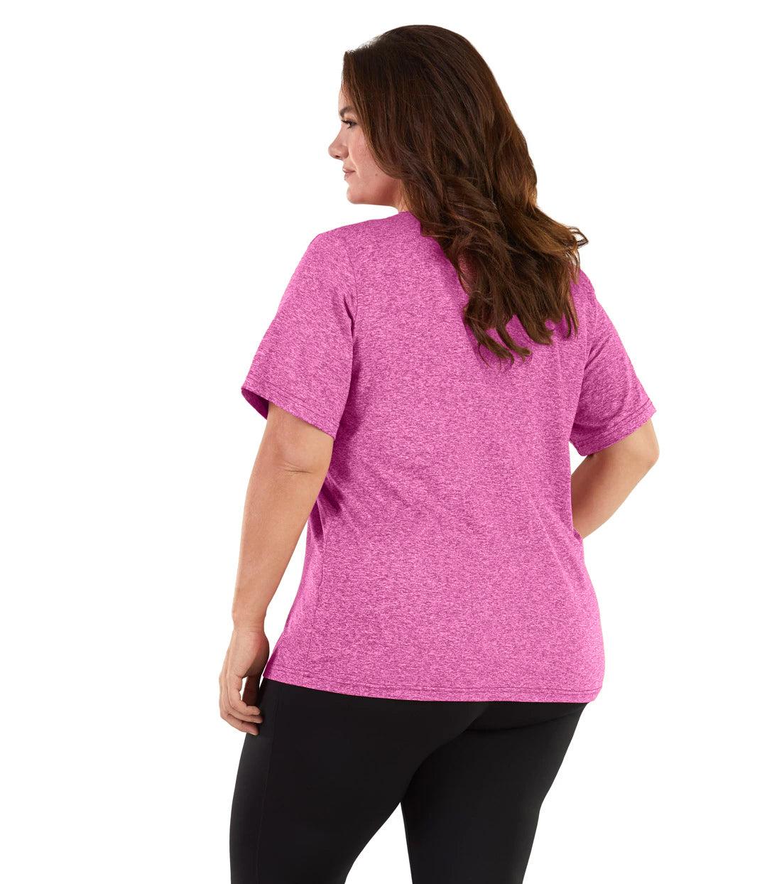 Plus size woman, facing back and looking left, wearing JunoActive plus size SoftWik V-Neck Tee in the color Heather Fuchsia. She is wearing JunoActive Plus Size Leggings in the color black. 