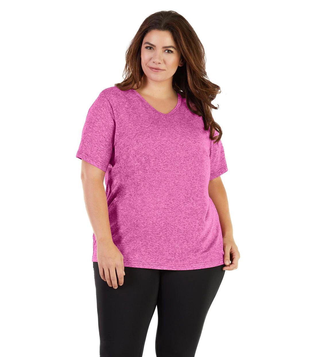 Plus size woman, facing front, wearing JunoActive plus size SoftWik V-Neck Tee in the color Heather Fuchsia. She is wearing JunoActive Plus Size Leggings in the color black. 