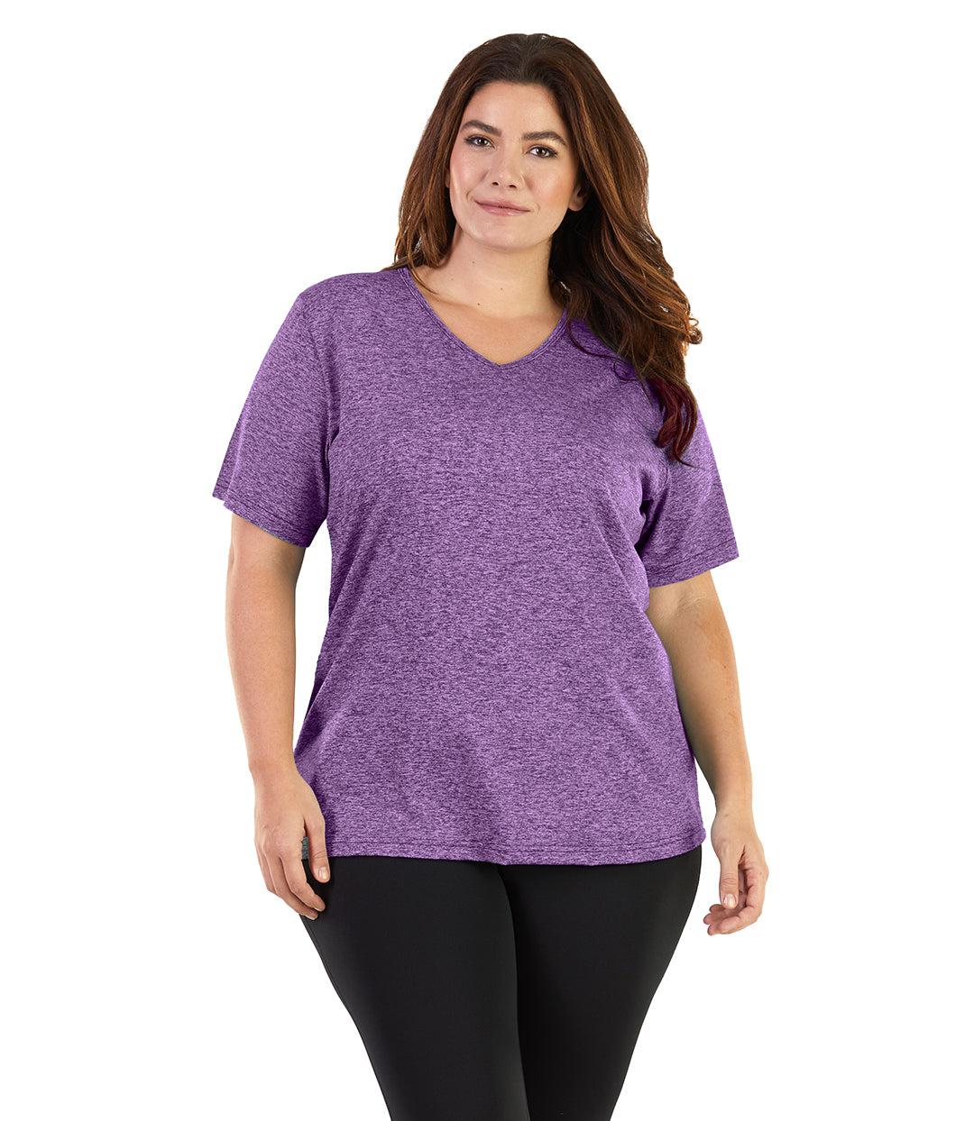Plus size woman, facing front, wearing JunoActive plus size SoftWik V-Neck Tee in the color Heather Purple. She is wearing JunoActive Plus Size Leggings in the color black. 