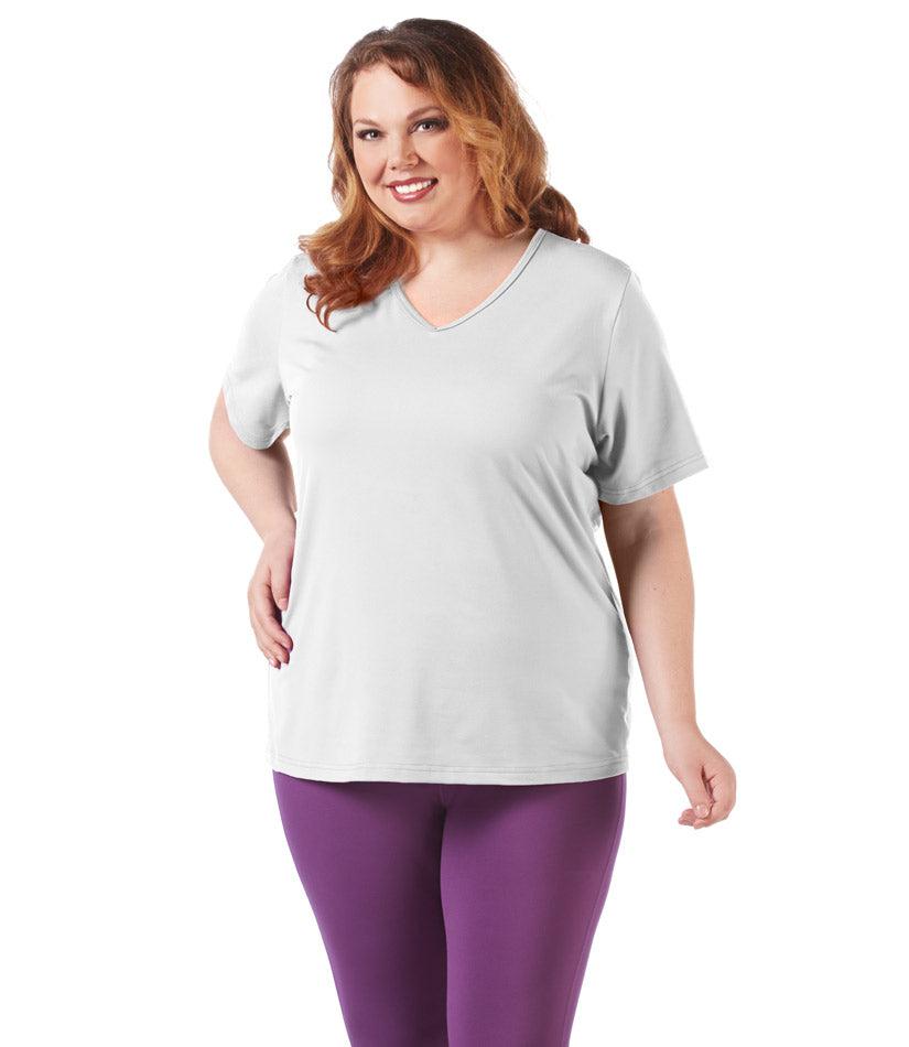 Plus size woman, facing front, wearing JunoActive plus size SoftWik V-Neck Tee in the color White. She is wearing JunoActive Plus Size Leggings in the color Grape. 
