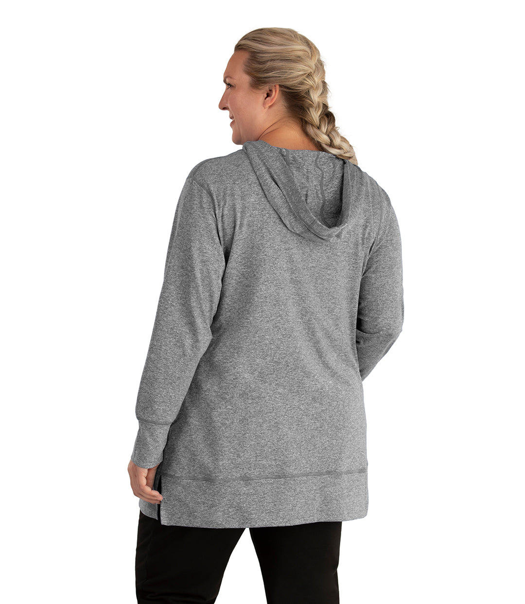 Plus size woman, facing back looking left, wearing JunoActive plus size SoftWik Long Sleeve Hoodie in the color Heather Grey. She is wearing JunoActive Plus Size Leggings in the color Black.