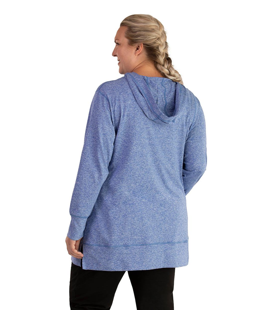 Plus size woman, facing back looking left, wearing JunoActive plus size SoftWik Long Sleeve Hoodie in the color Heather Royal. She is wearing JunoActive Plus Size Leggings in the color Black.