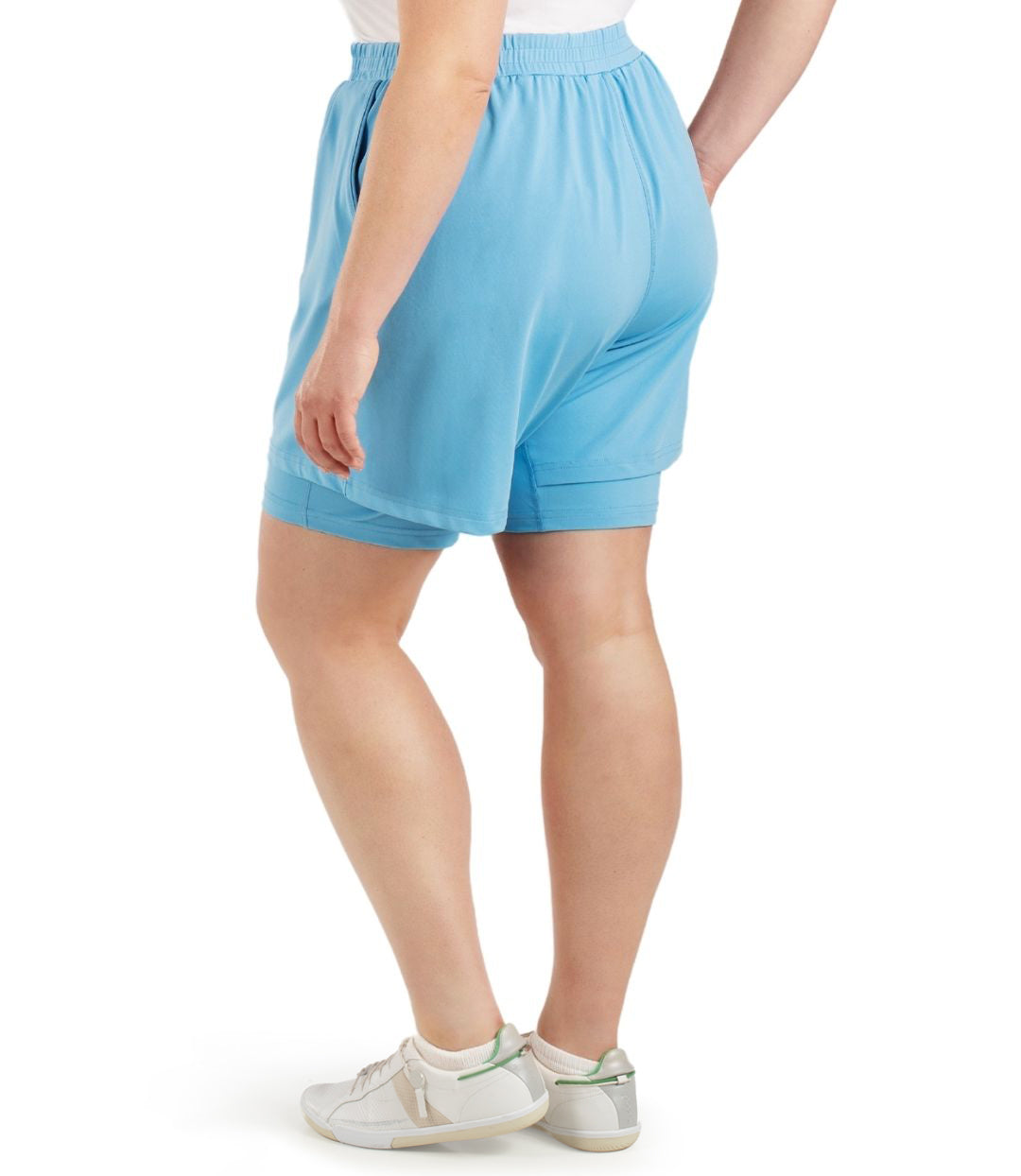 Back view of bottom half of plus sized model wearing JunoActives QuikWik Lite Dual Layer Short in Columbia blue. There are two layers with the bottom being a tight bike short and the outer layer a looser material.