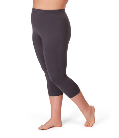 Bottom half of plus sized woman, side view, wearing JunoActives Quikwik Long Capris in color carbon. Bottom hem is at mid-calf. 