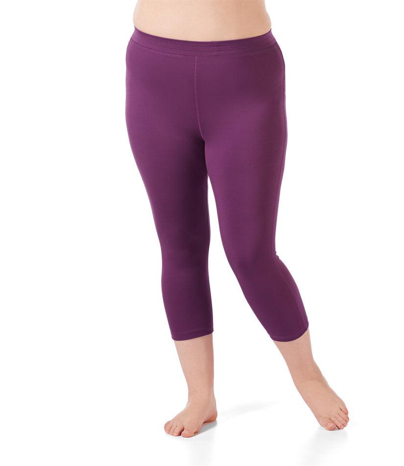 Bottom half of plus sized woman, front view, wearing JunoActives Quikwik Long Capris in color eggplant. Bottom hem is at mid-calf. 
