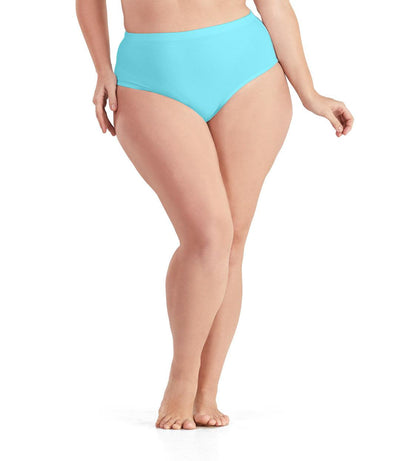Bottom half of plus sized woman, facing front, wearing JunoActive QuikWik Comfort Briefs in light turquoise. This brief fits just below the belly button with conservative leg opening.