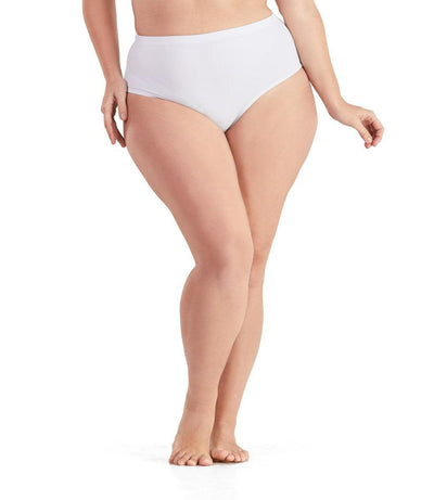 Bottom half of plus sized woman, facing front, wearing JunoActive QuikWik Comfort Briefs in white. This brief fits just below the belly button with conservative leg opening.