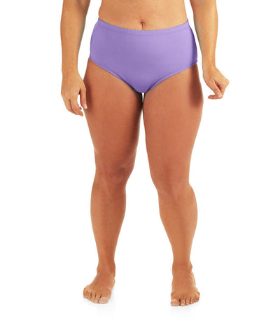 Bottom half of plus sized woman, facing front, wearing JunoActive QuikWik Comfort Briefs in iris. This brief fits just below the belly button with conservative leg opening.
