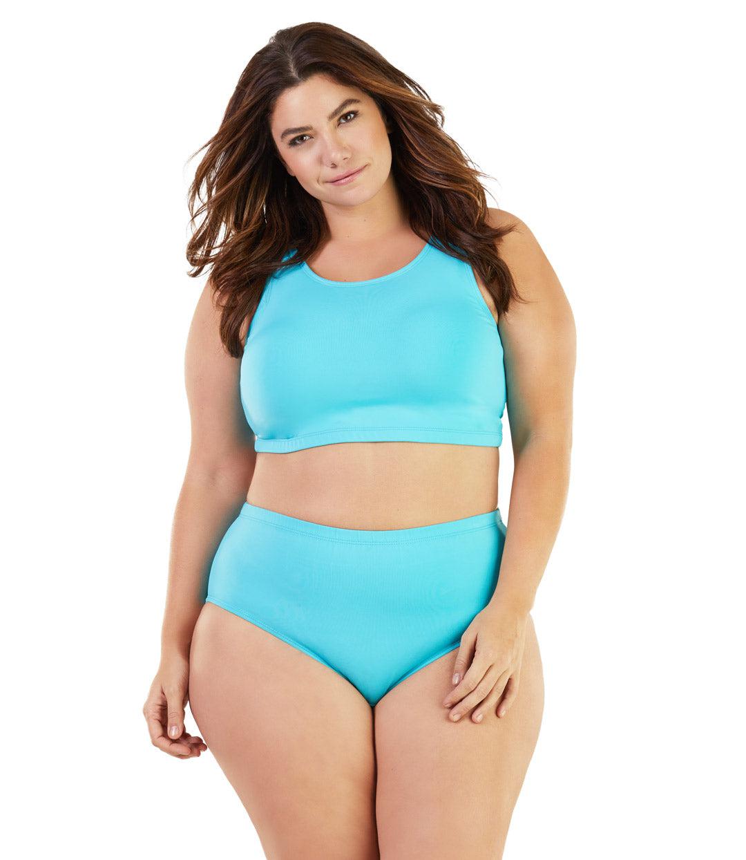 Plus size woman, facing front, wearing JunoActive plus size QuikWik Soft Control Bra Top in Light Turquoise. The woman is wearing a pair of coordinating QuikWik Comfort plus size Briefs in Light Turquoise. 