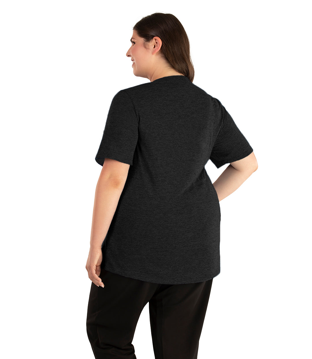 Plus size woman, facing back looking to the left, wearing JunoActive plus size QuikLite Scoop Neck Short Sleeve top in the color Heather Black. She is wearing JunoActive Plus Size Leggings in the color black. 