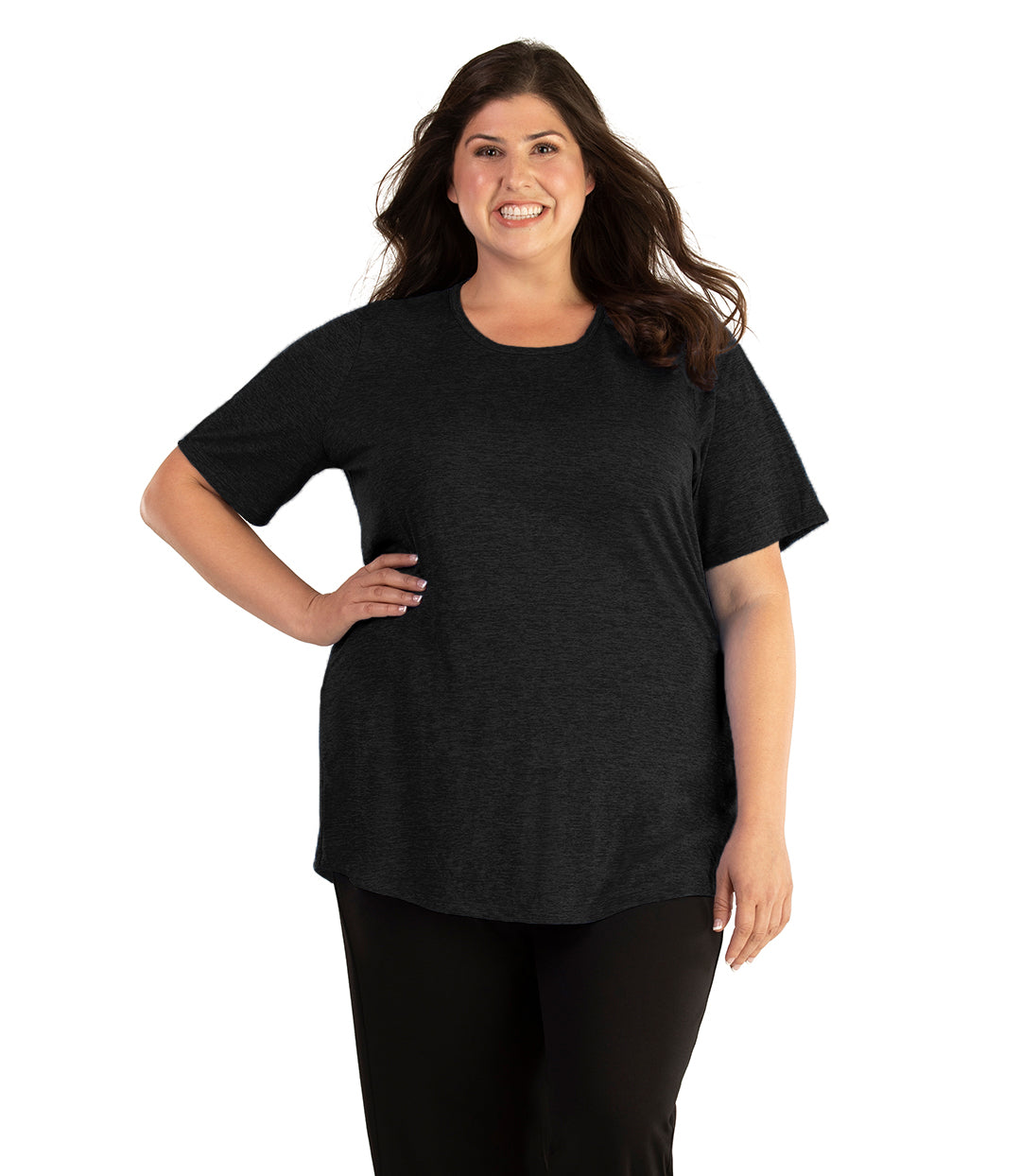 Plus size woman, facing front, wearing JunoActive plus size QuikLite Scoop Neck Short Sleeve top in the color Heather Black. She is wearing JunoActive Plus Size Leggings in the color black. 