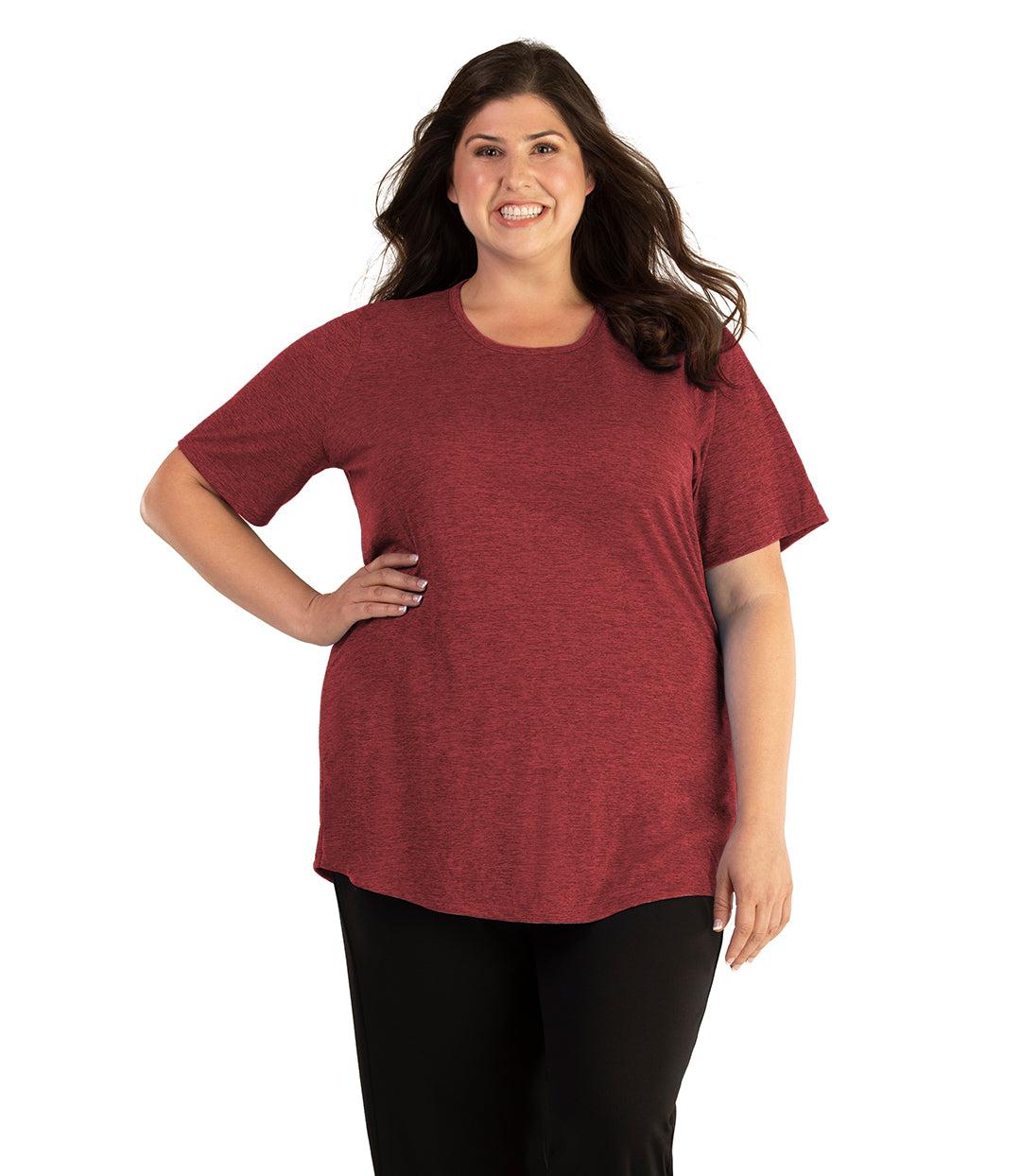 Plus size woman, facing front, wearing JunoActive plus size QuikLite Scoop Neck Short Sleeve top in the color Heather Garnet Red. She is wearing JunoActive Plus Size Leggings in the color black. 