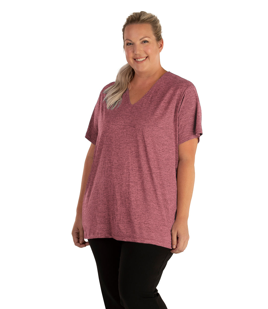 Plus size woman, facing front, wearing JunoActive plus size QuikLite V-Neck Short Sleeve top in the color Roseate. She is wearing JunoActive Plus Size Leggings in the color black. 