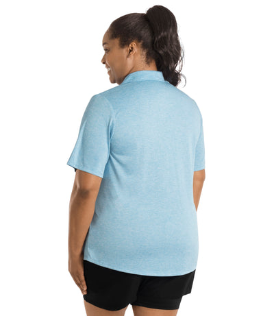 Plus size woman wearing JunoActive's SunLite Johnny Collar Top in heather light blue facing back.