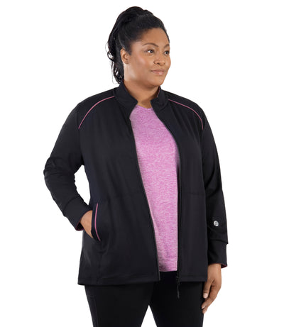 Plus size woman, facing front, wearing JunoActive's JunoStretch Mock Neck Jacket in color black with warm mauve lining cuffs and warm mauve piping details along shoulders and pockets. 