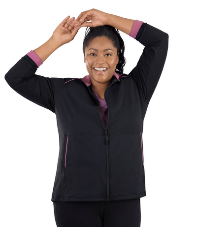 Plus size woman, facing front, wearing JunoActive's JunoStretch Mock Neck Jacket in color black with warm mauve lining cuffs and warm mauve piping details along shoulders and pockets. 