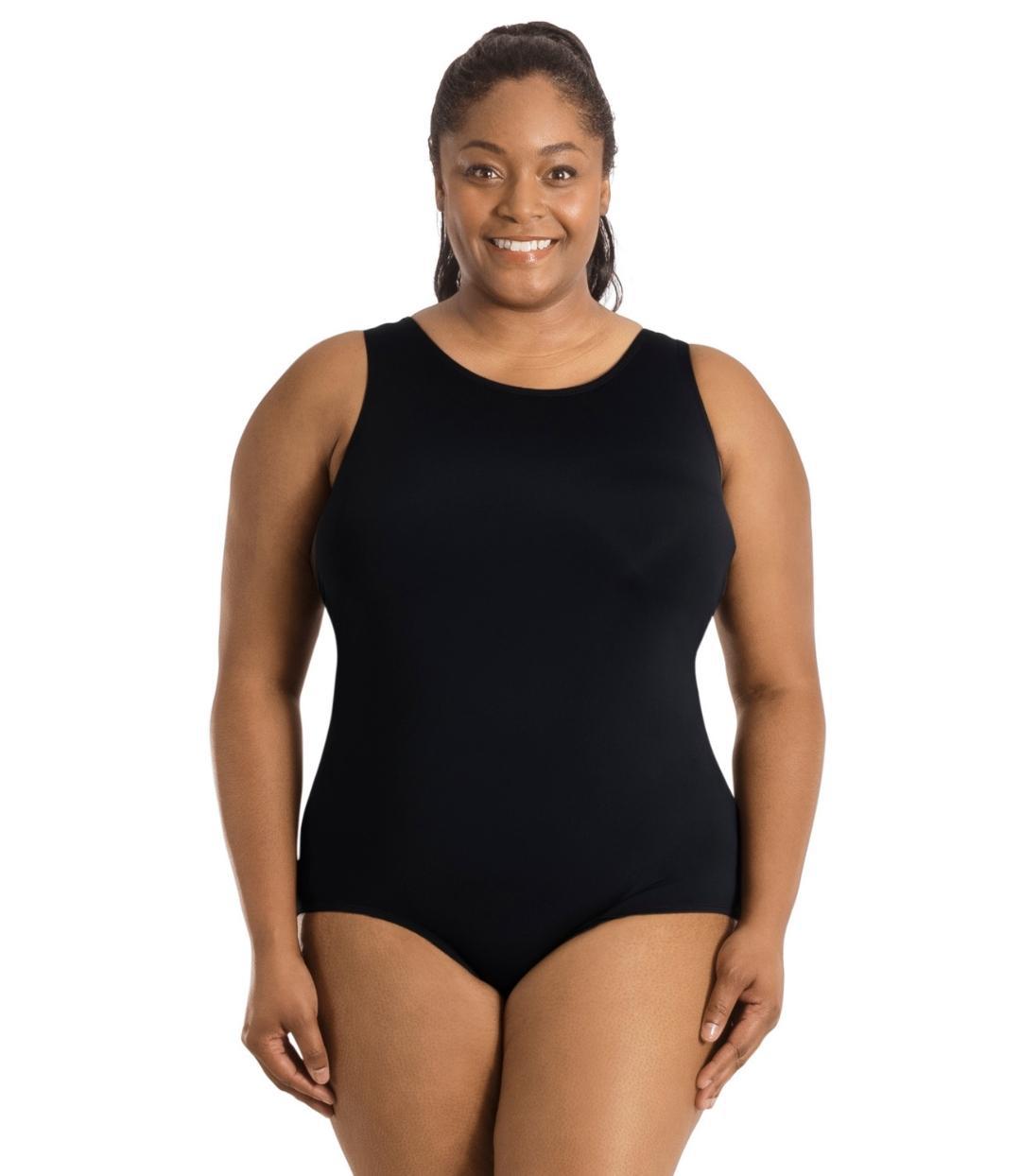 Plus size woman, facing front, wearing JunoActive plus size QuikEnergy Spa Suit Black. The suit is solid black, has a scoop neckline and conservative leg opening.