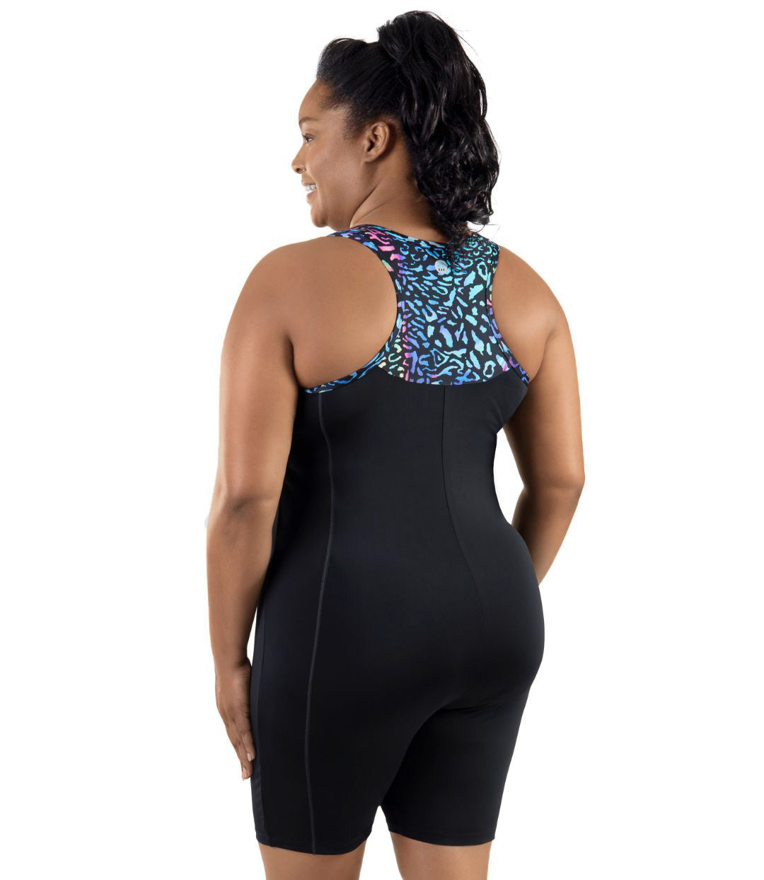 Plus-Size Model, facing back, wearing JunoActive's QuikEnergy Racerback Zip Front Aquatard in color reef print.