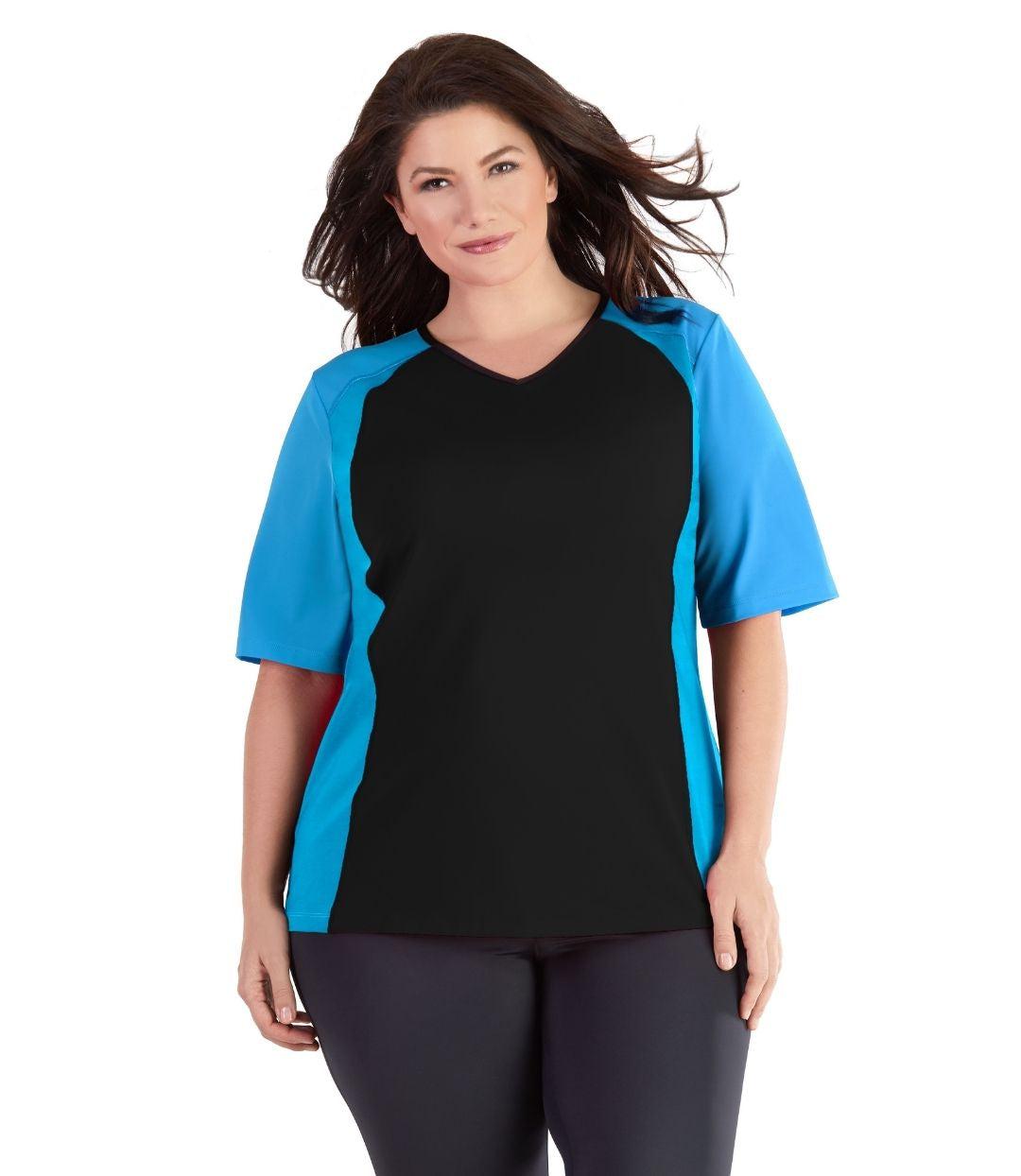 Plus size woman, facing front, wearing QuikEnergy Short Sleeve Swim and Sun Top Black and Turq. Solid Black on the center torso and solid turquoise colorblocking on the sleeves and waist. Long cover short sleeves meeting at the elbow.  