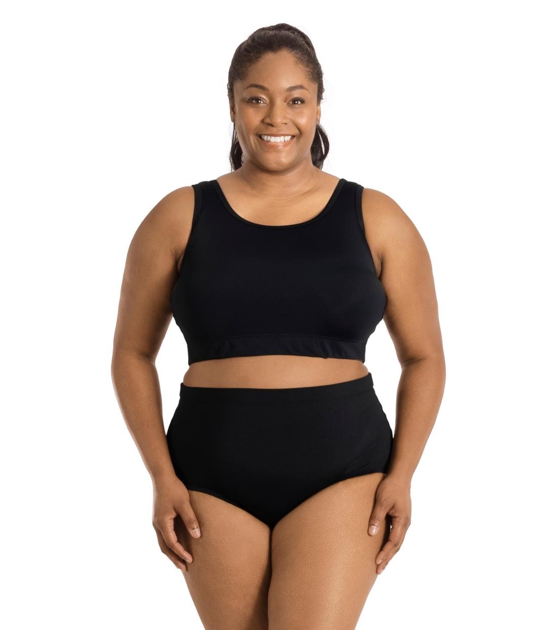 Plus size woman, facing front, wearing QuikEnergy Swim Bra Black. Conservative scoop neck front with elastic band at the ribcage.