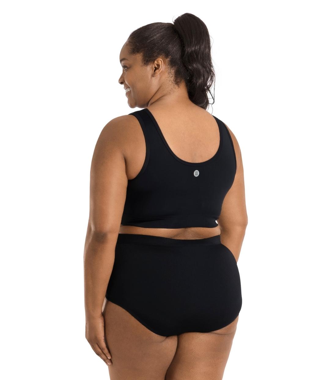 Plus size woman, back view, wearing QuikEnergy Swim Bra Black. Scoop back with elastic at the ribcage and JunoActive logo at center back.