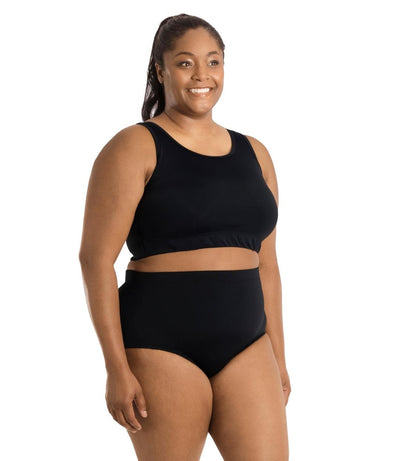 Plus size woman, side facing view, wearing QuikEnergy Swim Bra Black. Conservative scoop neck front with elastic at the ribcage.