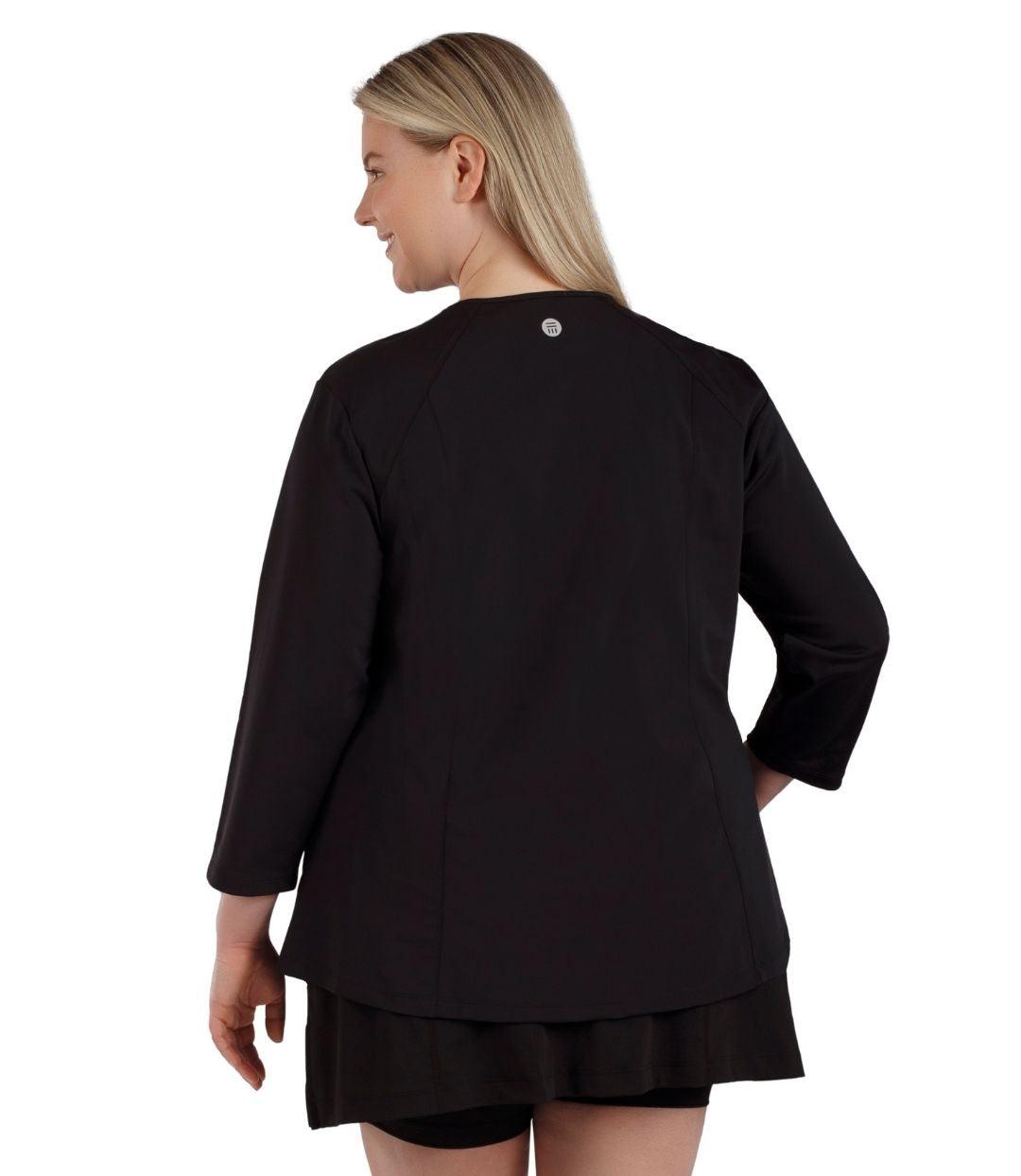 Plus size woman, back view, wearing QuikEnergy  ¾ Sleeve Swim and Sun Top Black and Turq. Solid black back and sleeves. 