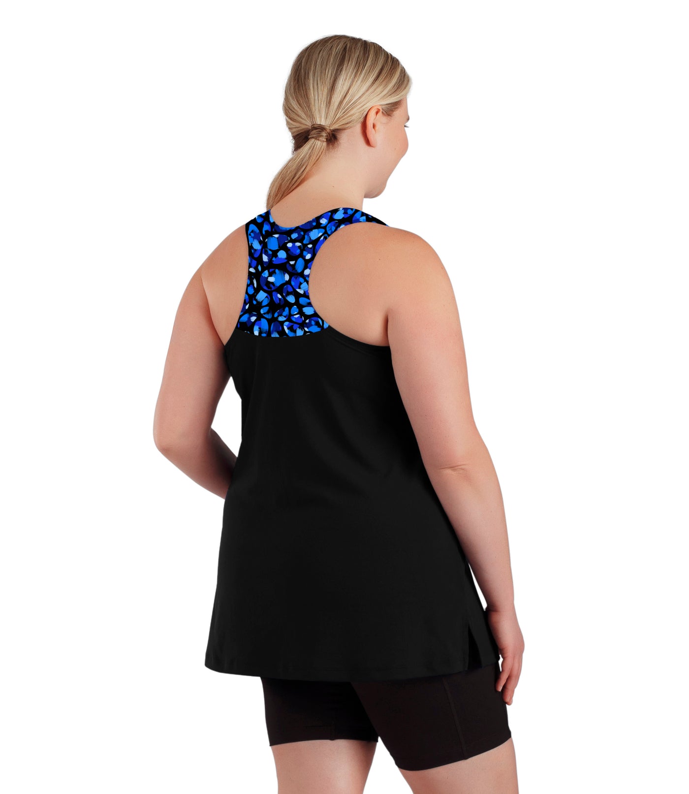 Plus size woman, facing back view, wearing AquaSport Hanalei Tankini Top Ocean Blues Print Black. The back of the tankini is razor back with the top portion covered in a blue bubble print. The bottom of the tankini is solid black falling right below the bottom. 
