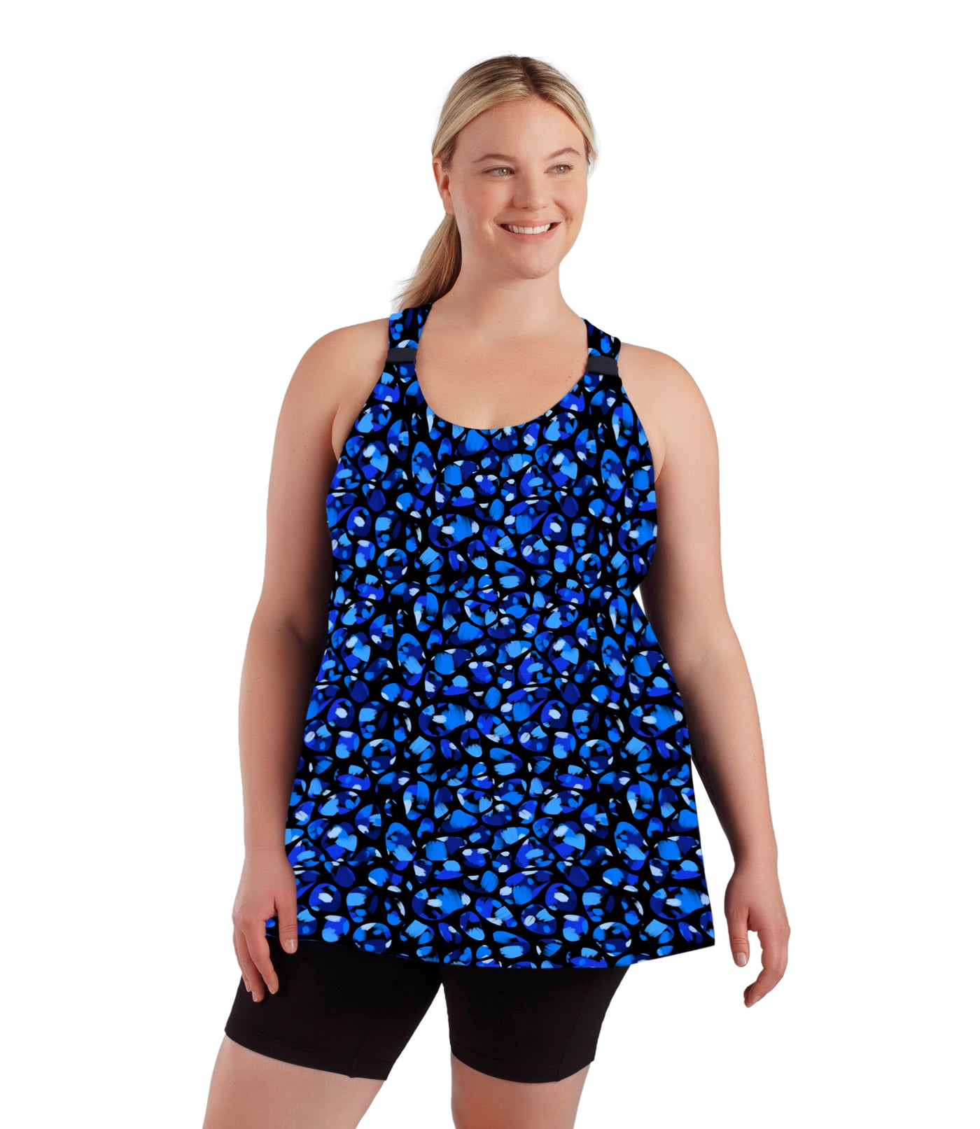 Plus size woman, facing front, wearing JunoActive plus size AquaSport Hanalei Top Ocean Blues Print Black. The tankini has a cinched shoulder detail in front, vents at the side seams, and a blue bubble print. 