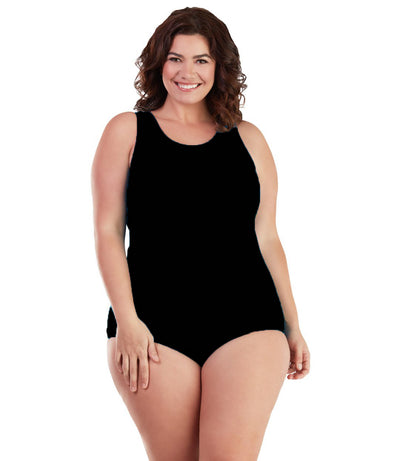 Plus size woman, facing front, wearing JunoActive plus size AquaSport Crossback Tanksuit Black. The main body of the suit is solid black, has a scoop neckline and conservative leg opening.