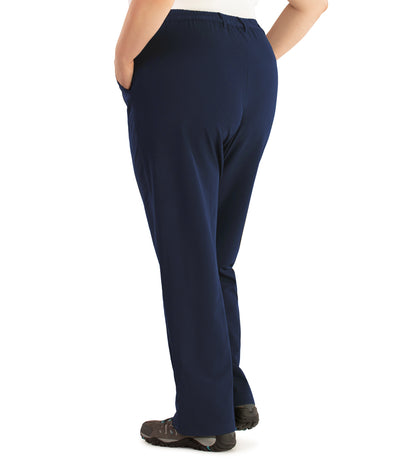 Bottom half of plus sized woman, back view, wearing JunoActive Hiking and Travel Pant in navy blue. These pants are full length and have pockets on each side.