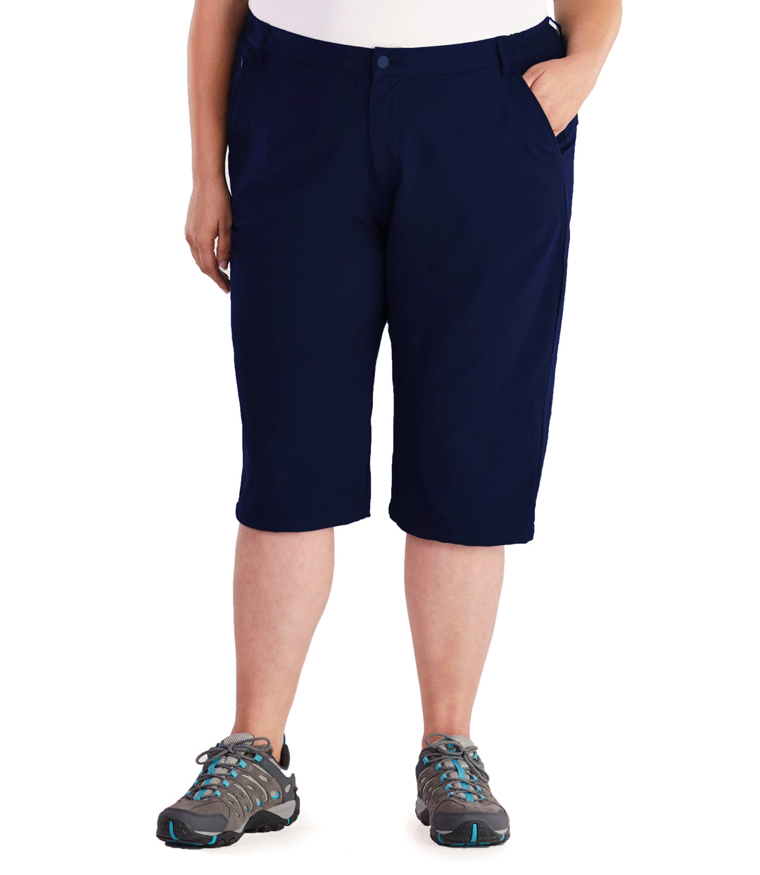 Bottom half of plus sized woman, front view, wearing JunoActive Hiking and Travel Short in color navy. Bottom hem is just below the knee. She is wearing hiking sneakers.