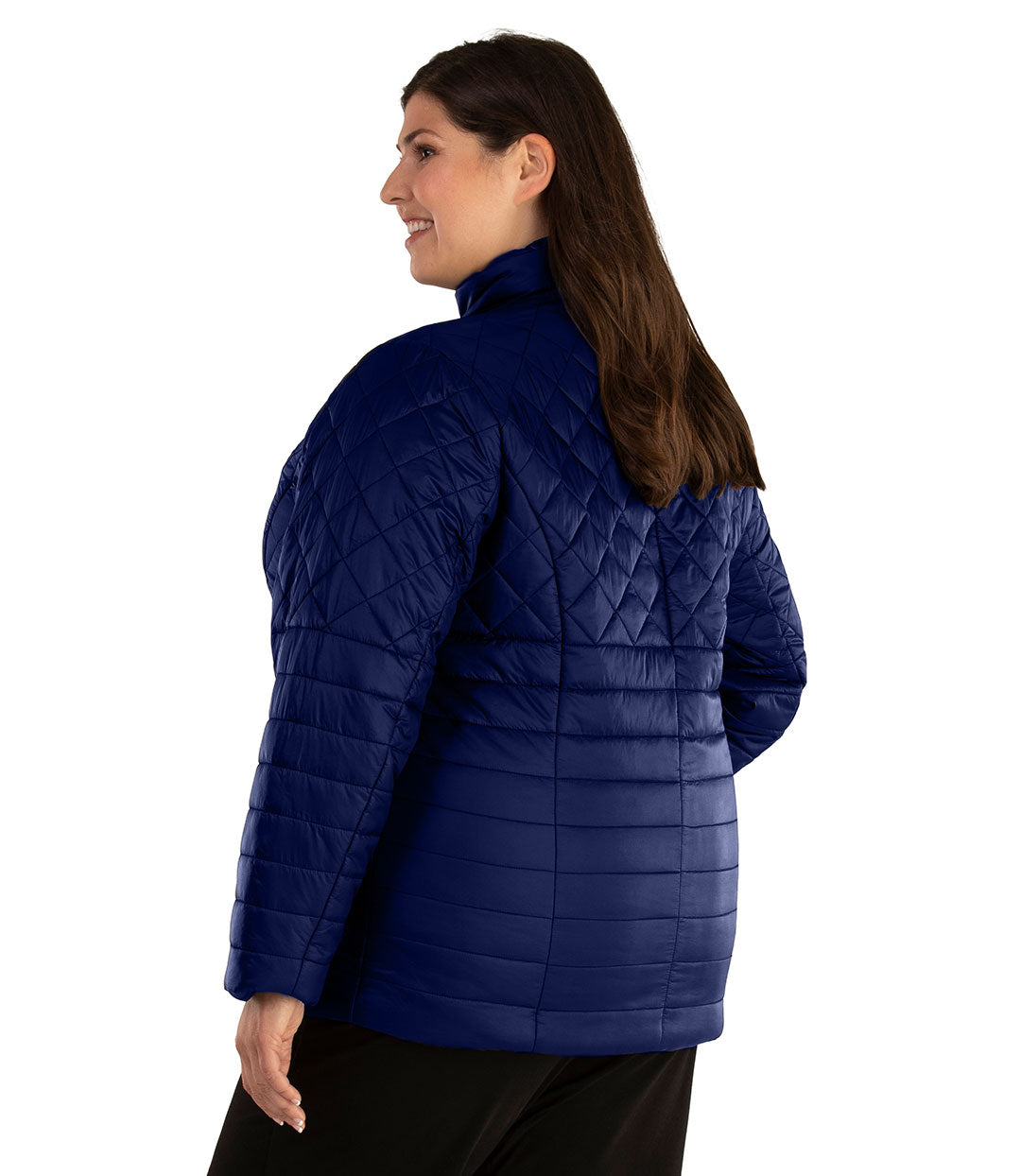 Plus size woman, back side view facing left, wearing a JunoActive plus size Quilted Active Length Jacket in Sapphire Blue. The jacket has a mock neck collar, zip front closure, and side pockets. Jacket quilting is a diamond pattern at the shoulders and horizontal lines at the lower half of the jacket. The length of the plus size jacket hits at the hips.