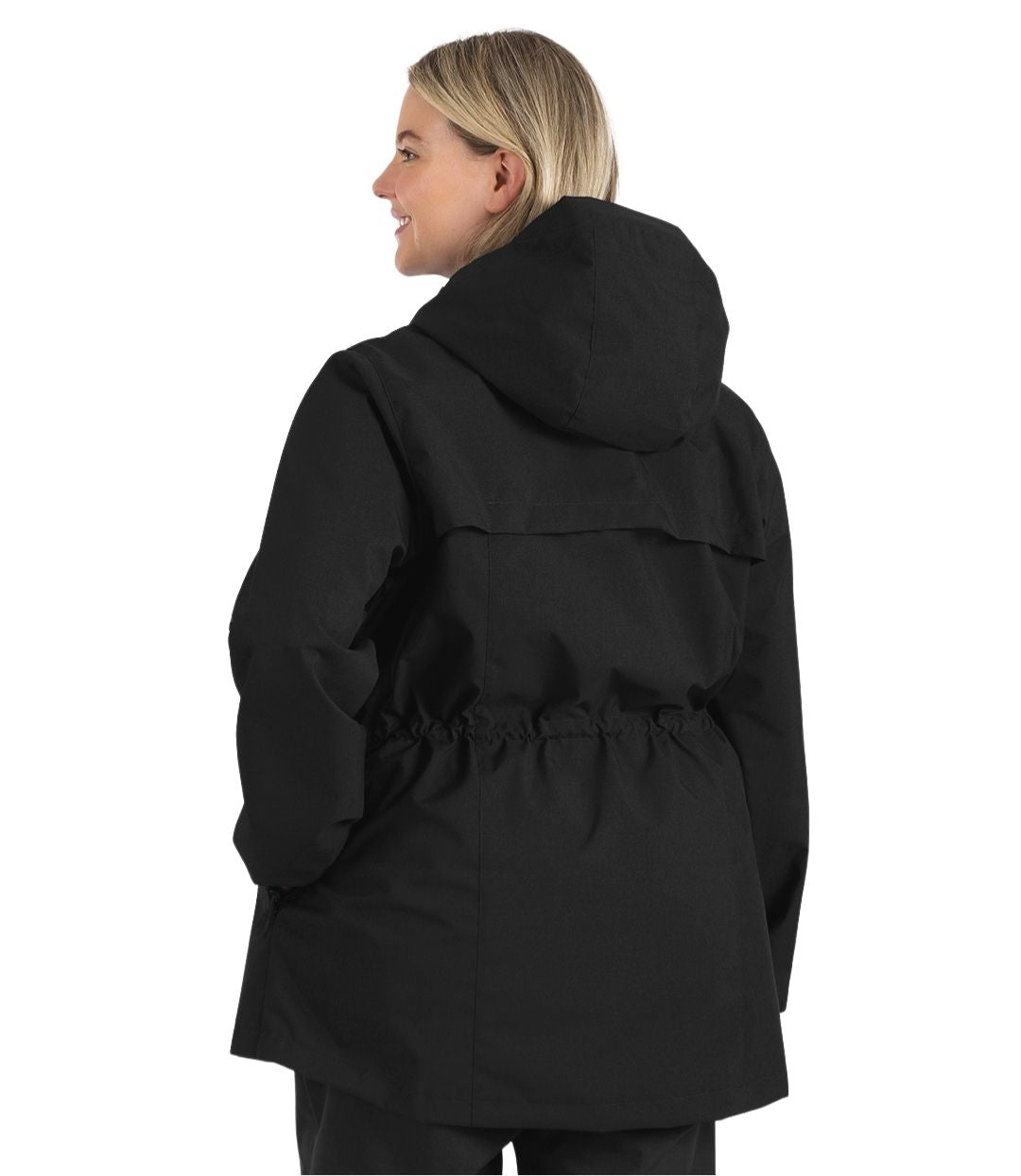 Plus size woman, back view, wearing a black JunoActive plus size wind and rain jacket. The jacket has a cinched waist, hood, double front closure and side pockets. The length of the plus size jacket hits just below the hips.