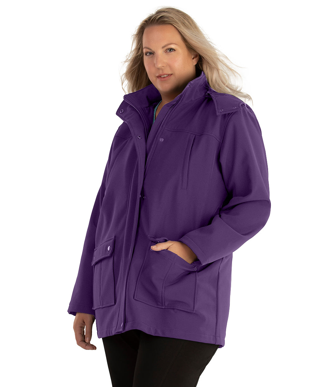 Plus size woman, front side view facing left, wearing a JunoActive plus size Hooded Softshell Jacket in Amethyst Purple. The jacket has a removeable hood, zip front closure, zip chest pocket, and snap patch pockets at the hip. The length of the plus size jacket hits below the hips.