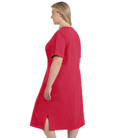 Plus size woman, facing to back left, wearing JunoActive plus size Stretch Naturals Short Sleeve Dress in the color Coraline.