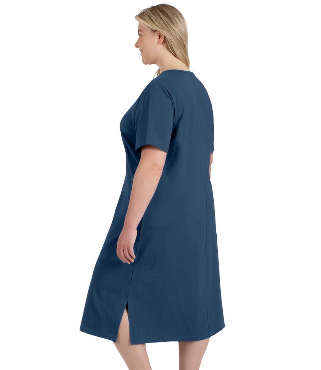 Plus size woman, facing to the back, wearing JunoActive plus size Stretch Naturals Short Sleeve Dress in the color denim blue.