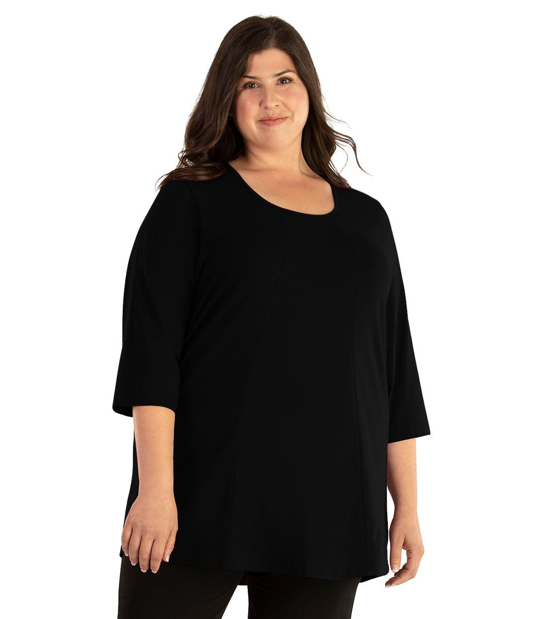 Plus size woman, facing front, wearing JunoActive plus size Stretch Naturals Lite ¾ Sleeve Swing Top in the color Black. She is wearing JunoActive Plus Size Leggings in the color Black. 
