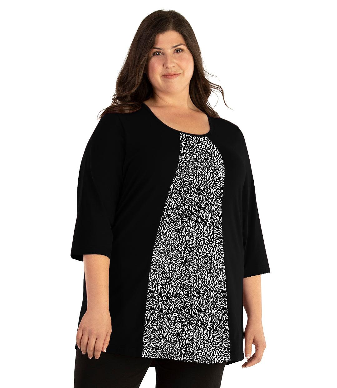 Plus size woman, facing front, wearing JunoActive plus size Stretch Naturals Lite ¾ Sleeve Swing Top in the color Wild Print. She is wearing JunoActive Plus Size Leggings in the color Black. 