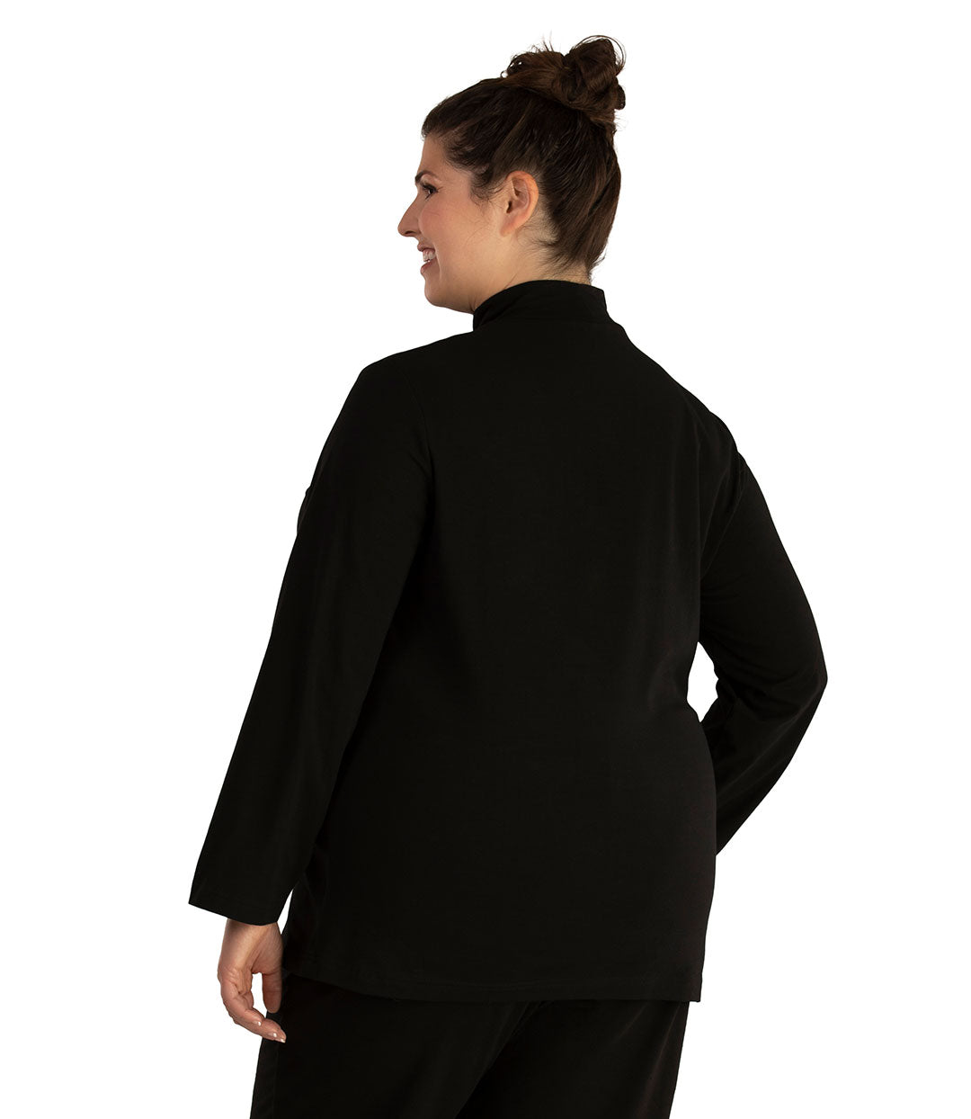 Plus size woman, facing back looking left, wearing JunoActive plus size Stretch Naturals Lite Mock Neck Top in the color Black. She is wearing JunoActive Plus Size Leggings in the color Black.